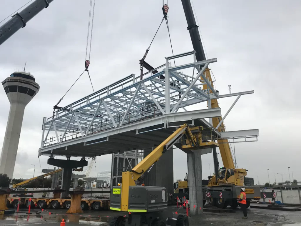 steel getting positioned by crane near airport